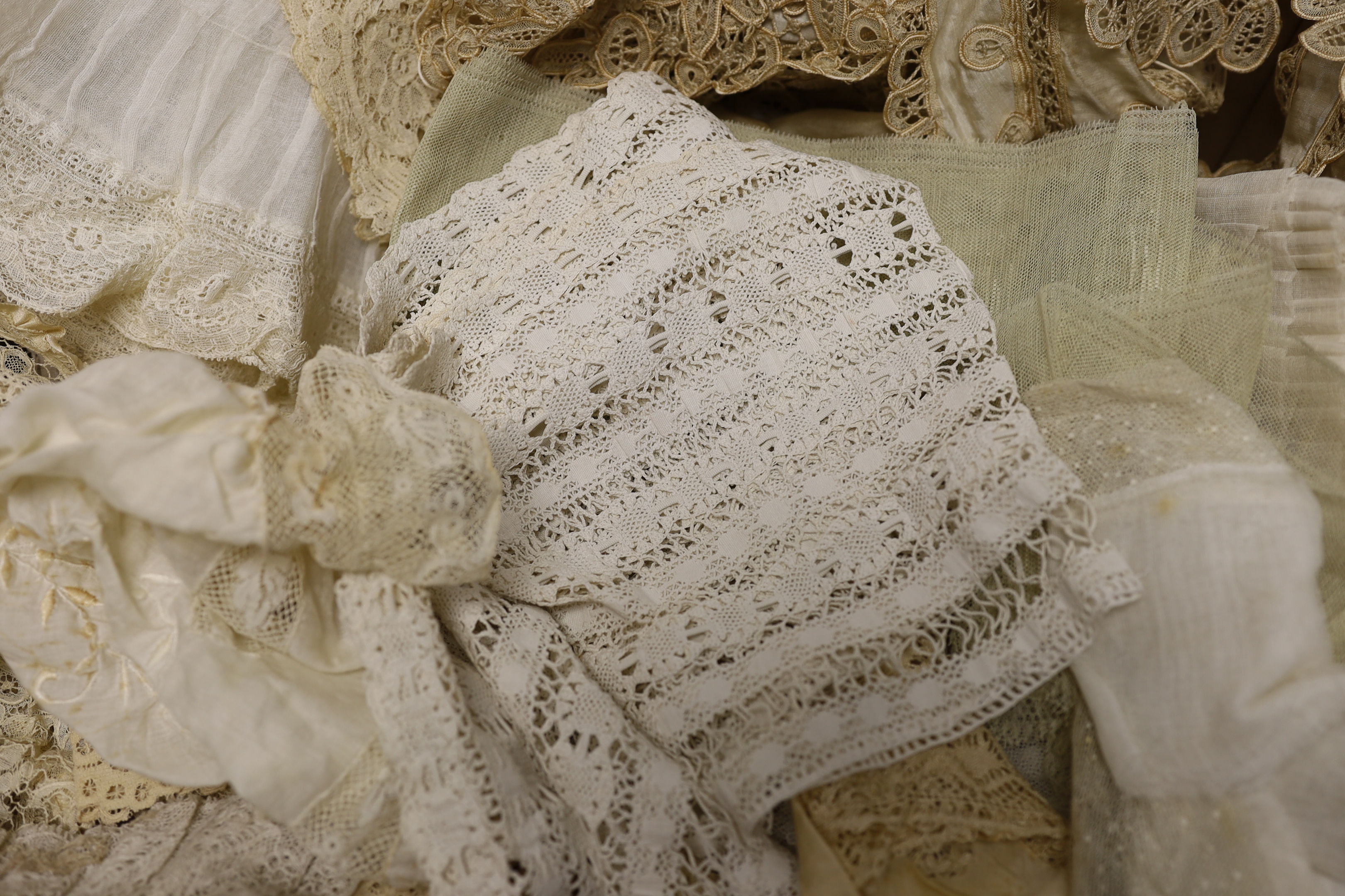 Mixed lace trimmings: a collection of Honiton bobbin lace trimming, a silk tape lace collar, various fine pleated gauze and lace edged trimmings, a silk skirt flounce, etc. A useful collection for making lace garments